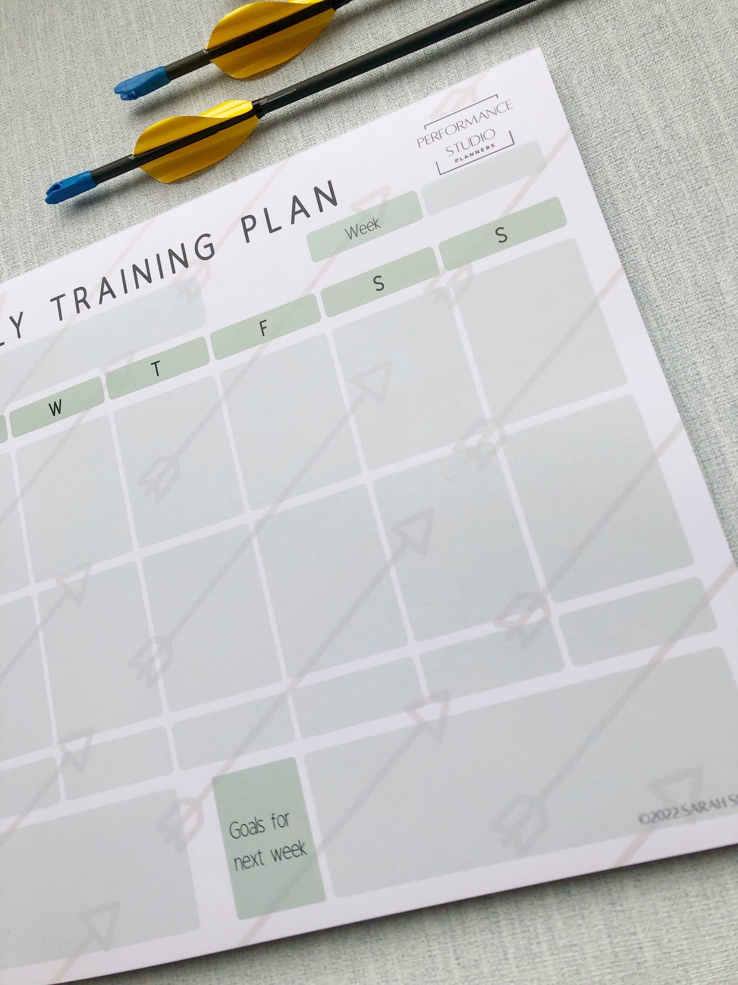 Green themed archery weekly planner. With different sections titled, goal for the week, plan for the session, session debrief, arrow count, key learnings, and goal for next week.