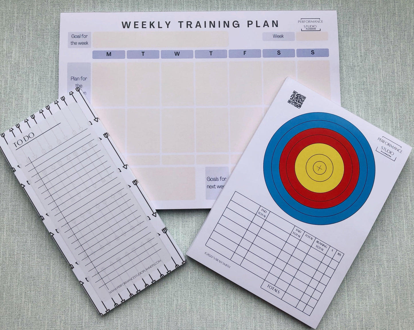 Archery weekly training planner, an archery target face plotting and scoring pad, and an archery themed to do notepad