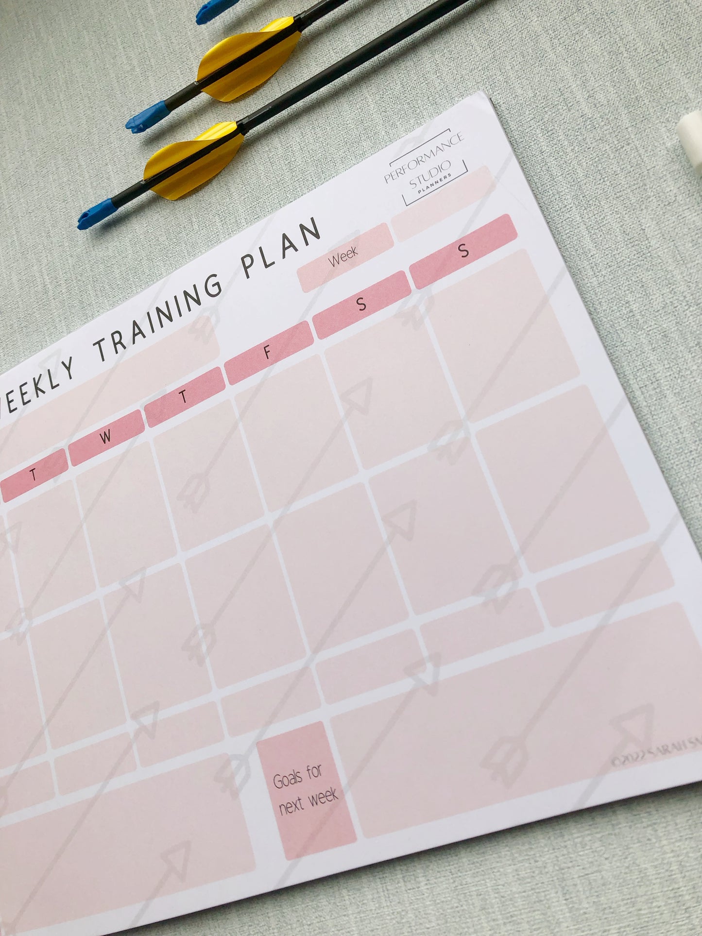pink themed archery weekly planner. With different sections titled, goal for the week, plan for the session, session debrief, arrow count, key learnings, and goal for next week.