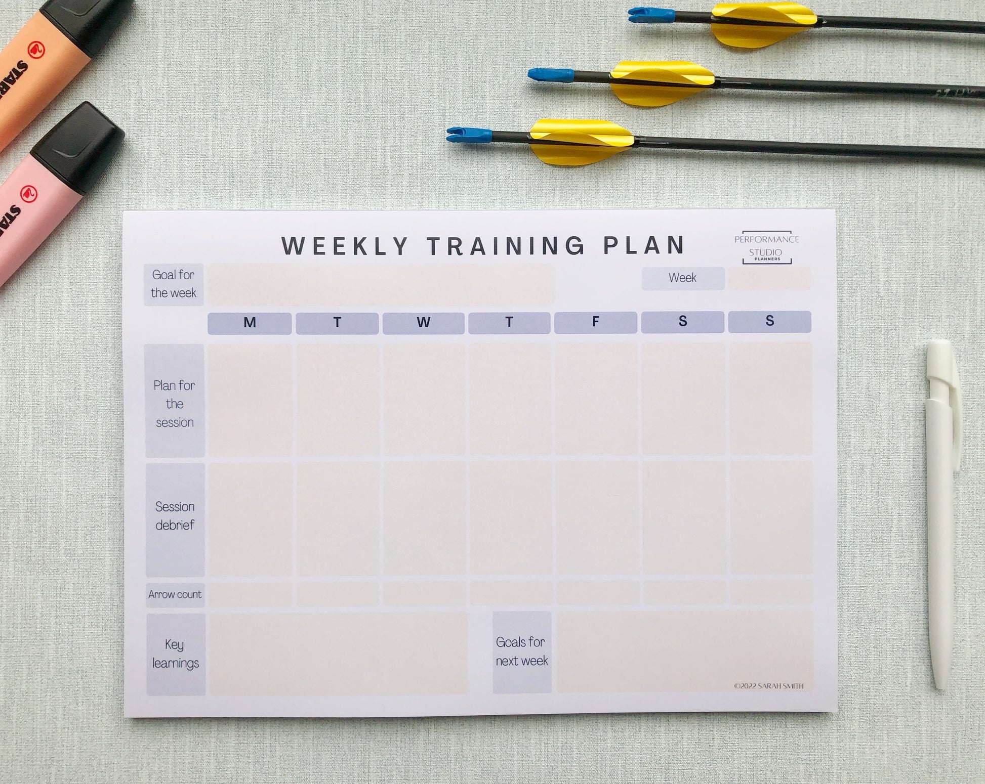 Purple themed archery weekly planner. With different sections titled, goal for the week, plan for the session, session debrief, arrow count, key learnings, and goal for next week.